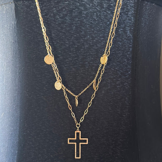 Layered gold colored chain necklace with coins and an open cross pedant.