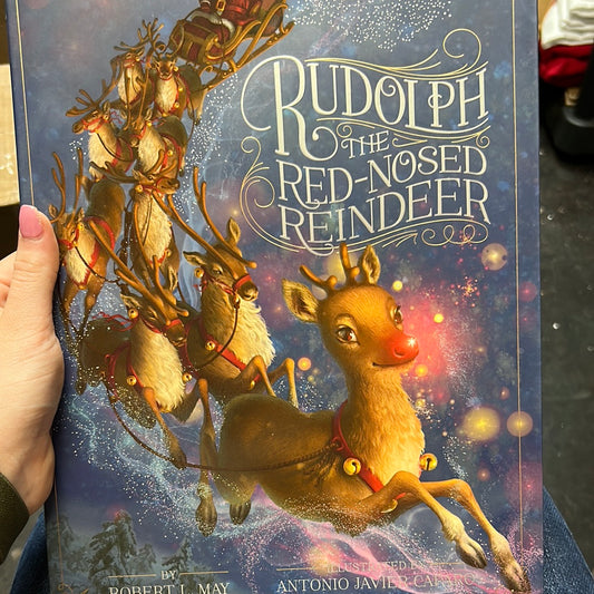 Book with Santa and his reindeer titling "Rudolph the Red-Nosed Reindeer.