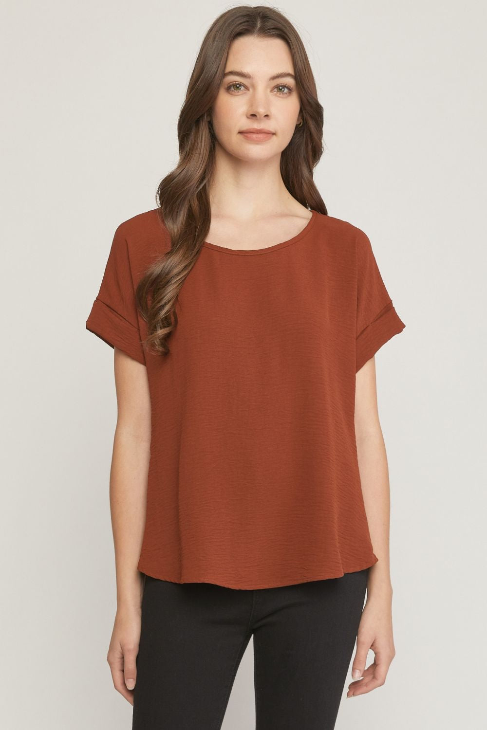 Chocolate scoop-neck top featuring permanent rolled sleeve detail and an asymmetrical hem.
