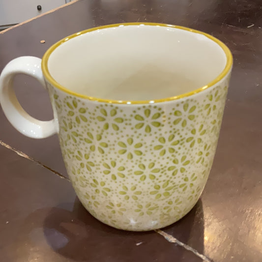 Hand stamped stoneware mug with a sage green floral pattern.