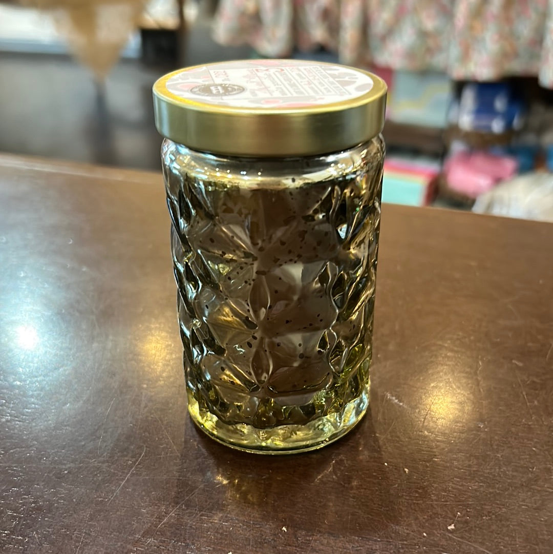 Candle in a small cylinder-shaped mercury glass jar.