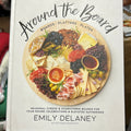 White book featuring a charcuterie board with "Around the Board" in black lettering.