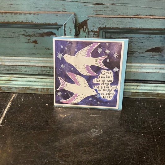 Card with two white birds featuring “Great teachers give us our wings and let us think we taught ourselves to fly.”
