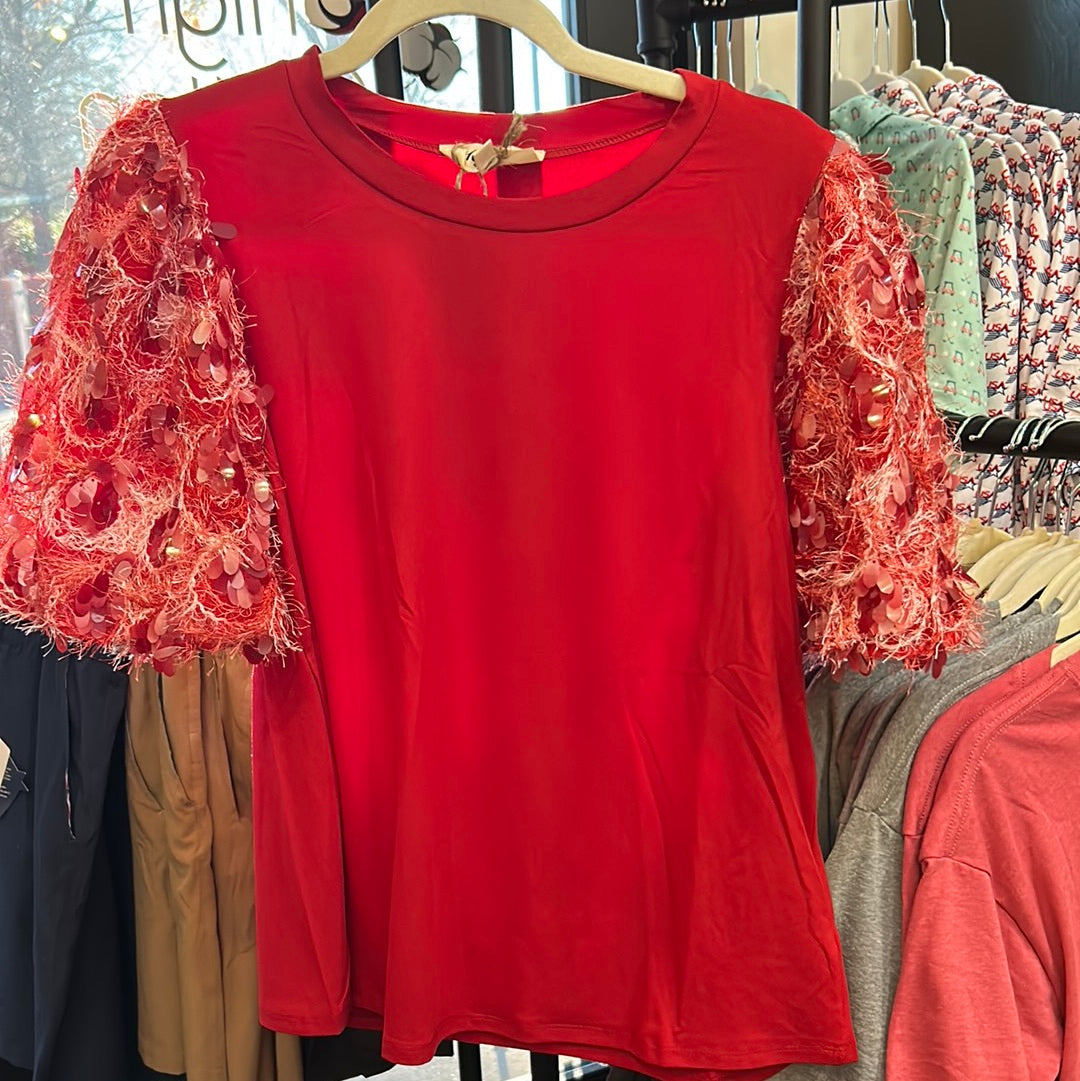 Red top with soft round neck and fringed sequin sleeves.