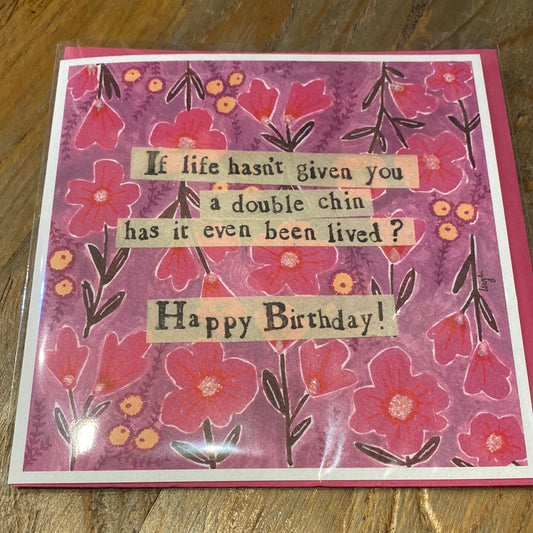 Purple card with pink flowers featuring “If life hasn’t given you a double chin, has it even been lived? Happy Birthday!”