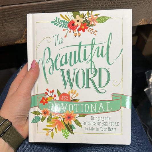 White book with floral designs titling "The Beautiful World" in blue lettering.