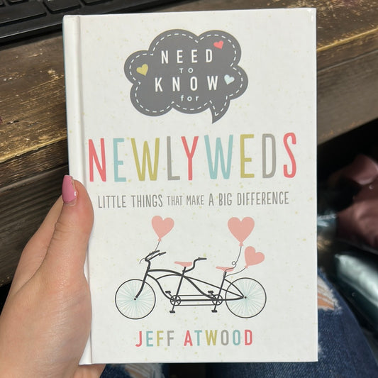 Book with a bike titled "Need to Know for Newlyweds; Little Things That Make A Big Difference".