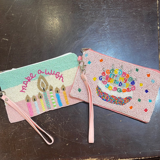 Assorted beaded birthday coin bag with a wristlet.
