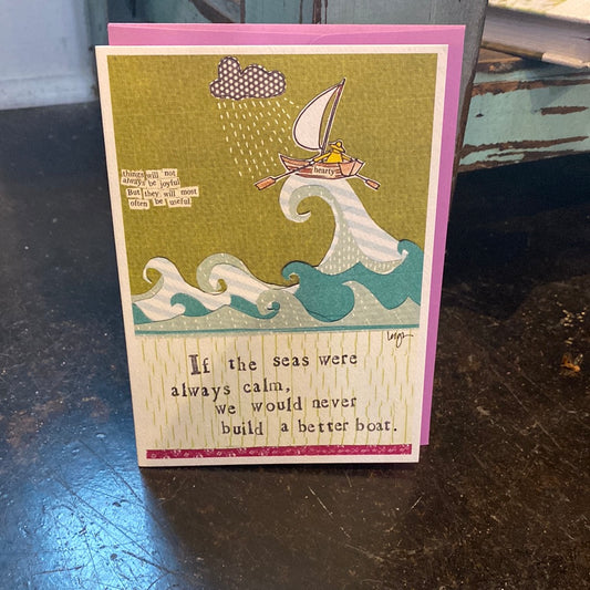 Card with a sailboat on a stormy sea. Says "If the seas were always calm, we would never build a better boat".