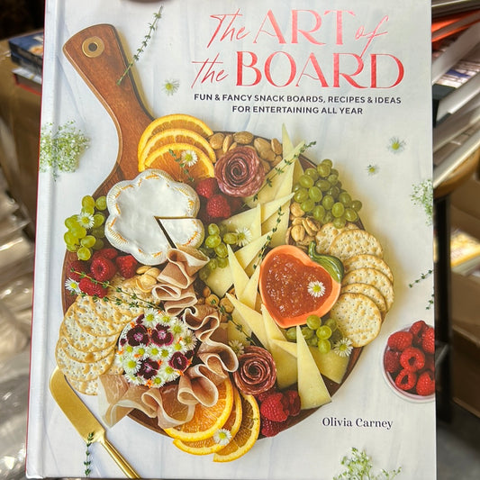 White book featuring a charcuterie board with "The Art of the Board" in red lettering.