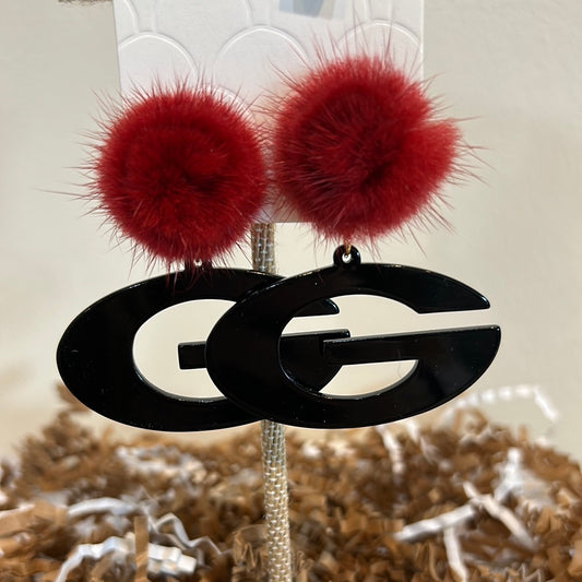 Black acrylic "G" logo earrings with a red puff stud.