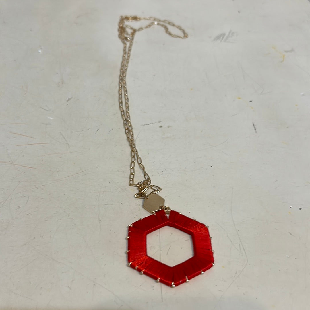 Red threaded hexagon game day necklace.