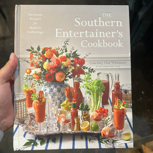 Book with drinks and floral arrangement titling "The Southern Entertainer's Cookbook".