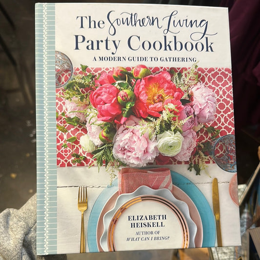 Book with flowers and place setting titling "The Southern Living Party Cookbook'.