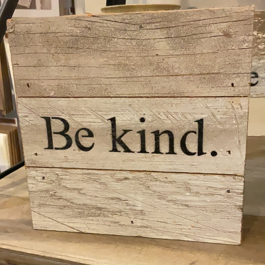 Wooden sign that says "Be Kind."