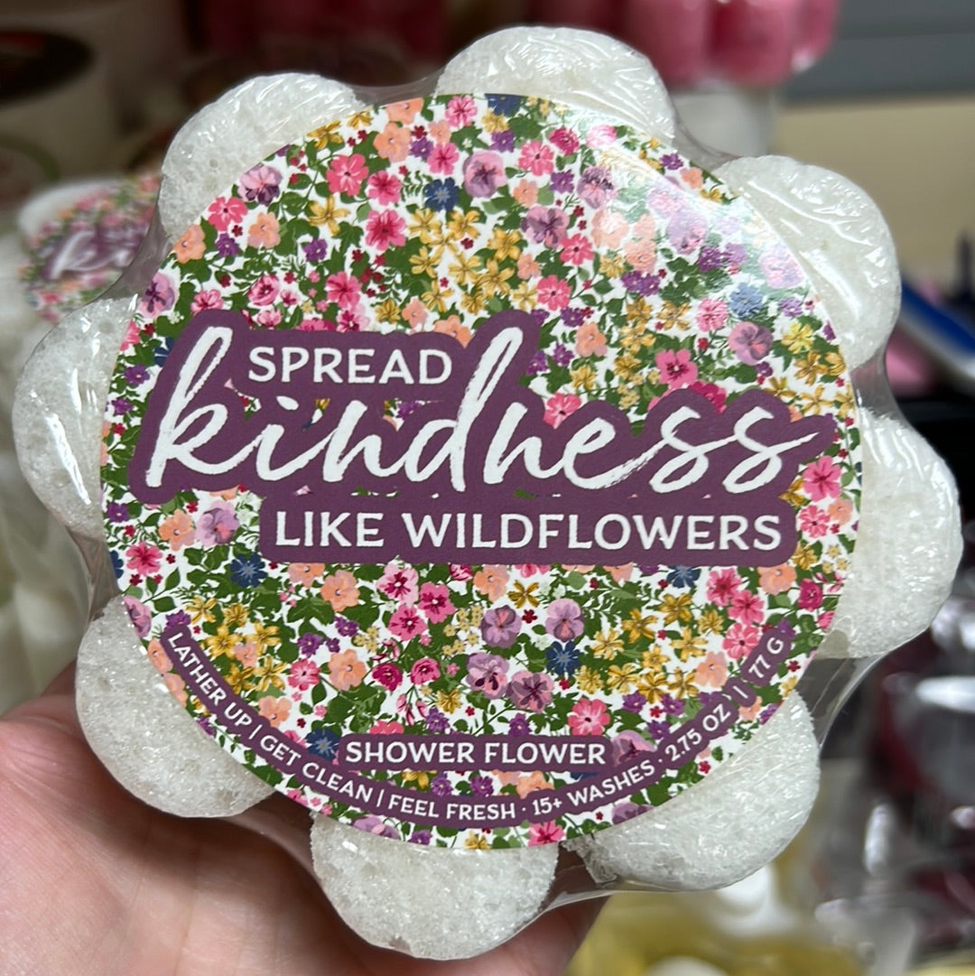 Caren "Spread kindness like wildflowers" soap sponge shaped like a white flower.