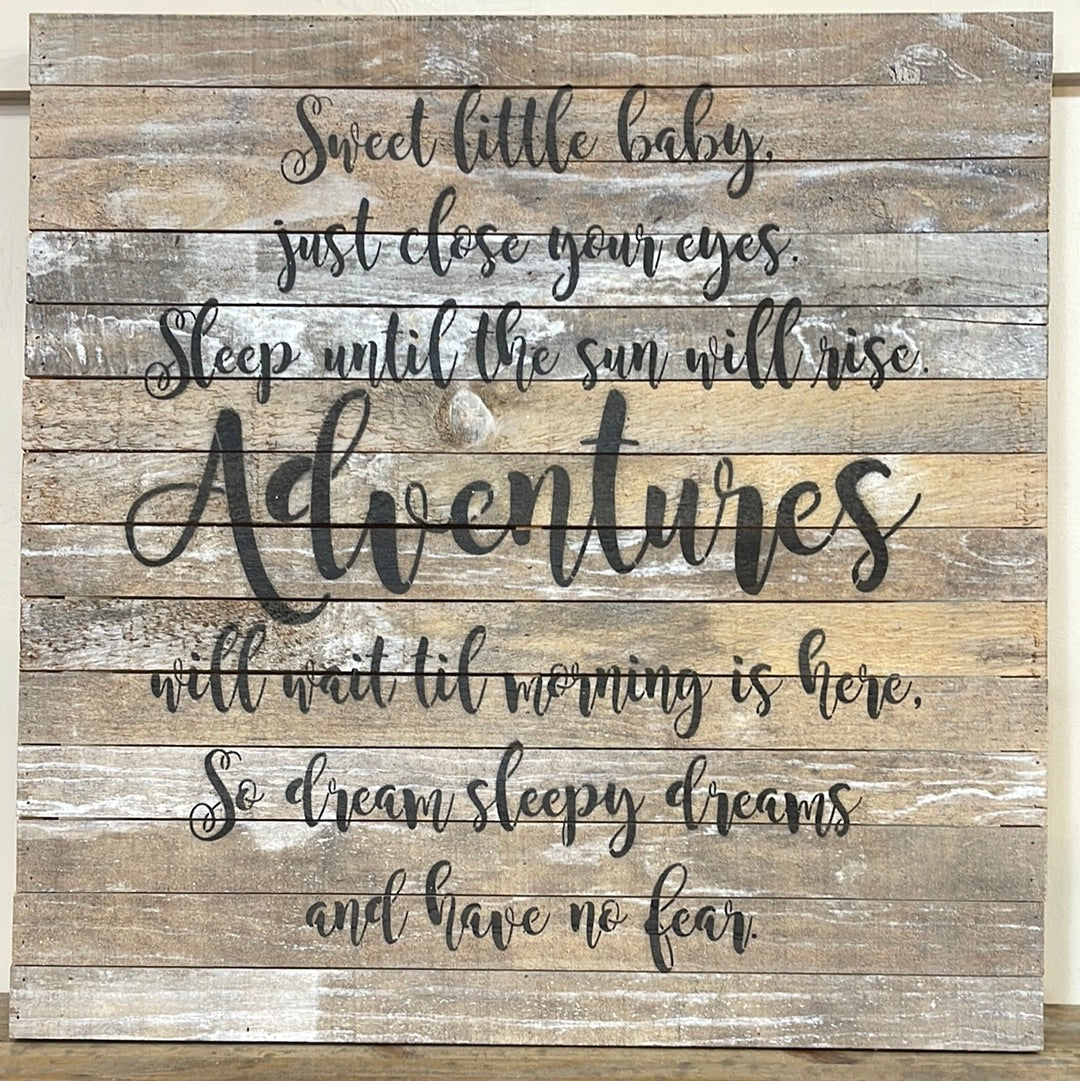 Wooden sign displaying "Sweet little baby, just close your eyes. Sleep until the sun will rise. Adventures will wait til morning is here. So dream sleepy dreams and have not fear."