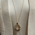 Geometric necklace in gold with golden chain.