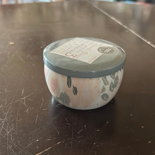 Candle in a tin, travel-sized container.