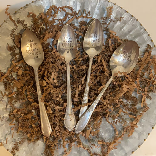 Engraved spoons with varying messages.