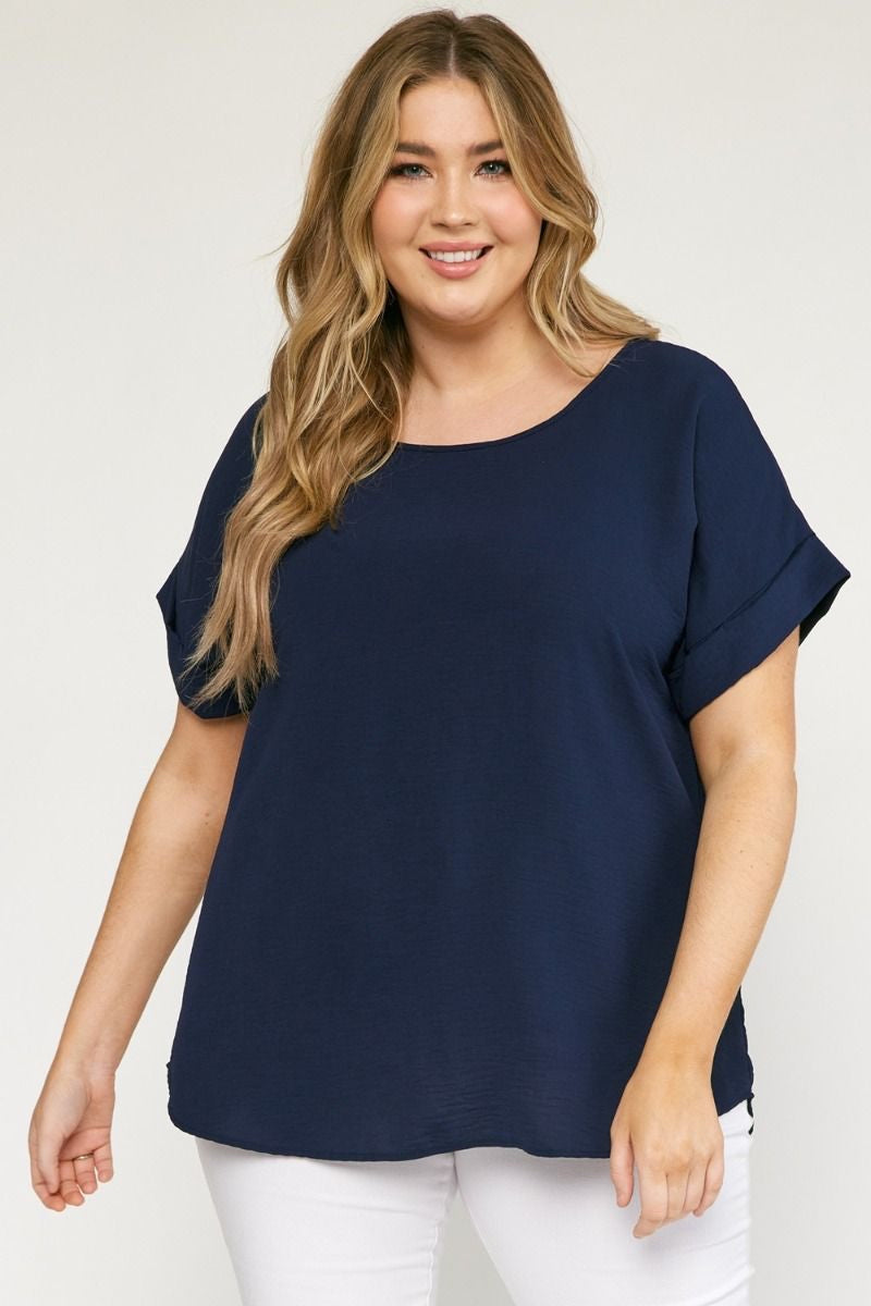Navy scoop-neck top featuring permanent rolled sleeve detail and an asymmetrical hem