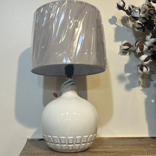 Large, white glazed ceramic lamp.