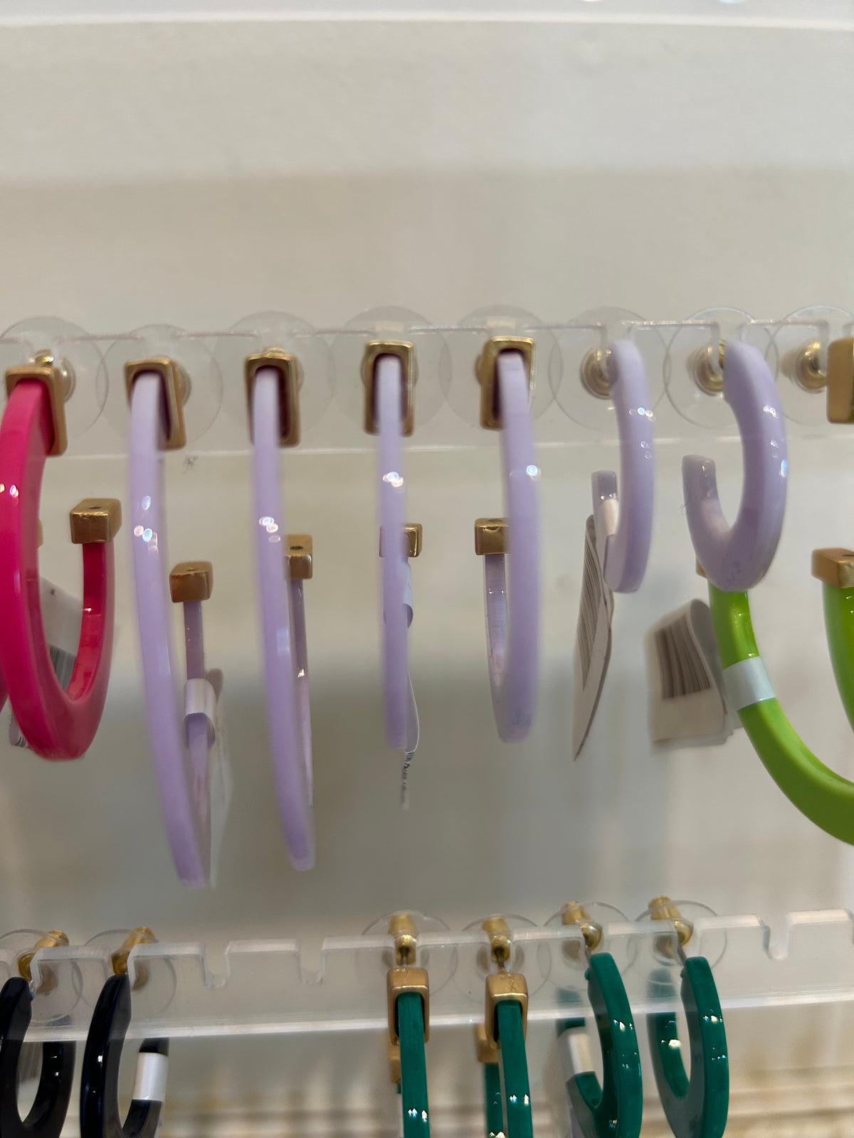 Light purple acrylic hoop earrings in three sizes.