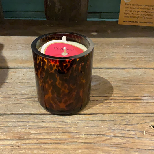 Candle in a tortoise shell glass.
