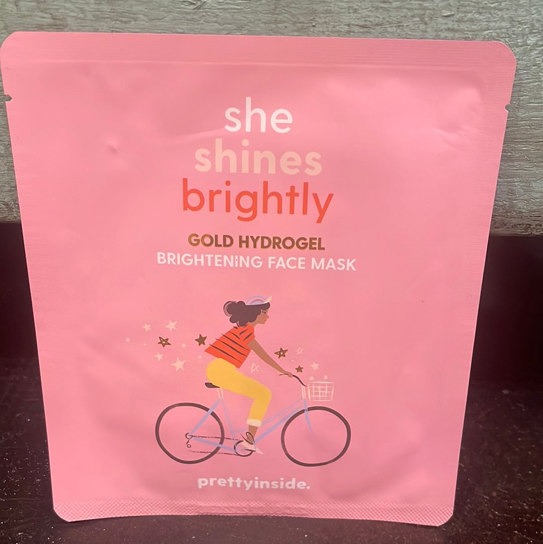"She shines brightly" gold hydrogel brightening face mask in pink packaging.