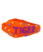 Orange top knot headband with jewels and "TIGER" in purple beading.