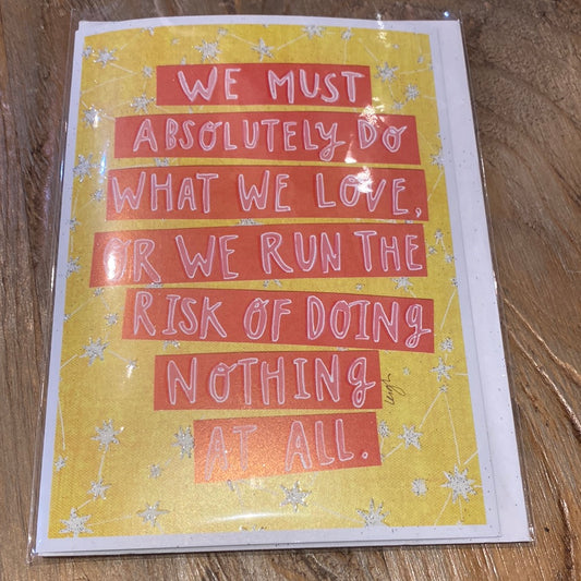 Yellow card with stars displaying “We must absolutely do what we love, or we run the risk of doing nothing at all.”