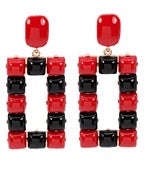 Red and black rectangle studded earrings.