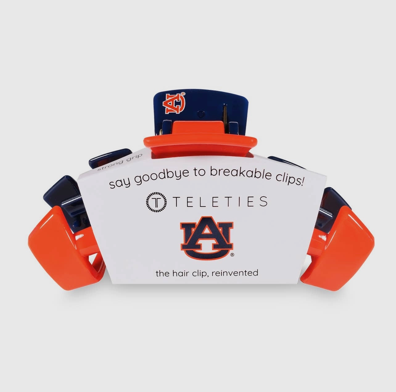University of Auburn Collegiate Teletie Claw Clip in orange and blue. Side view with packaging.