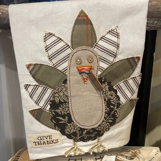 Dish towel with patchwork turkey displaying "GIVE THANKS".