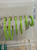 Light green acrylic hoop earrings in three sizes.