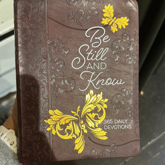 Brown cover with white lettering that says "Be Still And Know", and yellow butterflies.