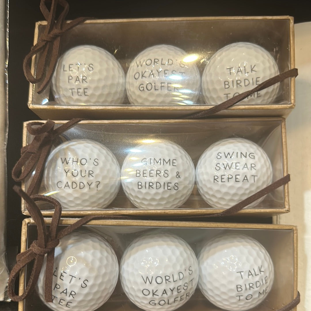Set of golf balls with funny sayings: "Let's par tee", "World's okayest golfer", "Talk birdie to me", "Who's your caddy?", "Gimme beers & birdies", "Swing swear repeat".