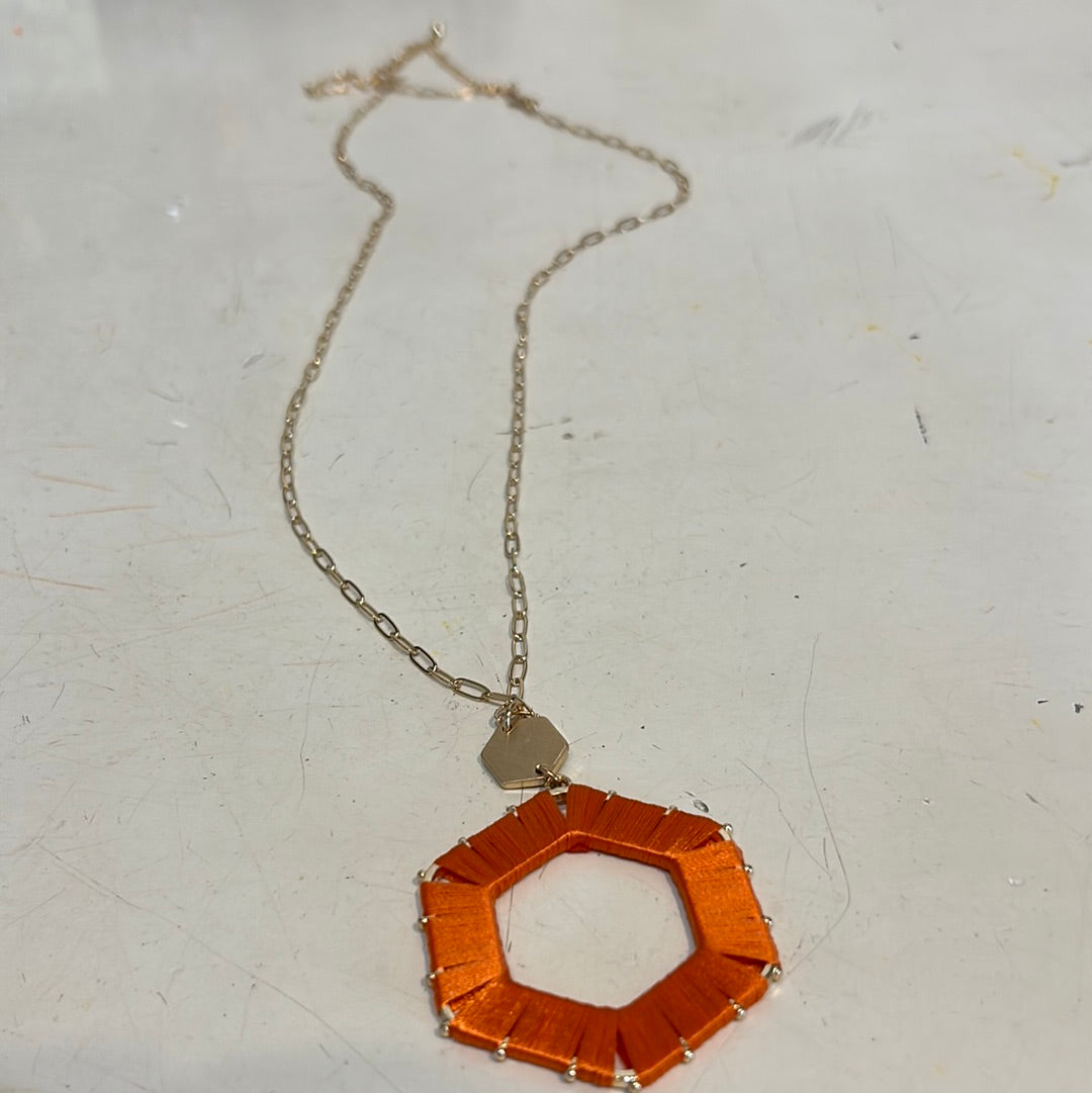 Orange threaded hexagon game day necklace.