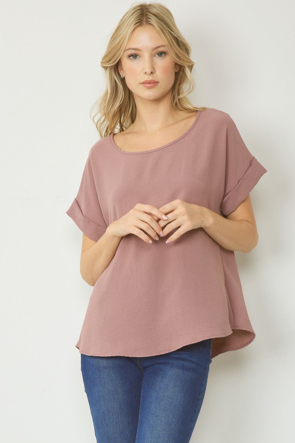 Mocha scoop-neck top featuring permanent rolled sleeve detail and an asymmetrical hem.