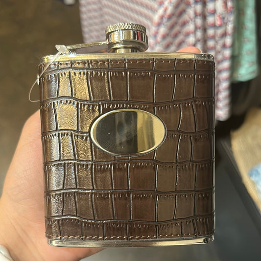 Brown leather flask with golden accents.