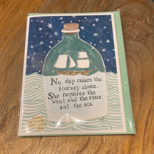 Card with a ship in a bottle featuring "No ship makes the journey alone. She requires the wind and the stars and the sea.”