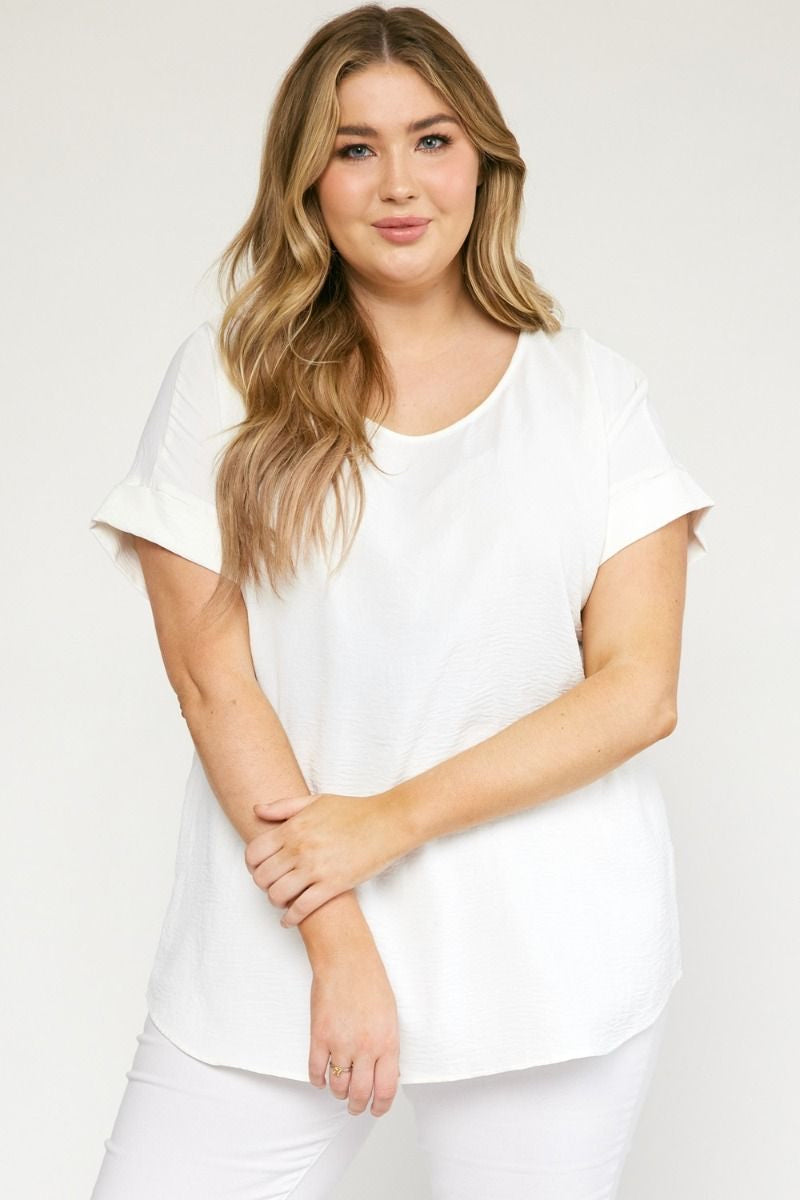 White scoop-neck top featuring permanent rolled sleeve detail and an asymmetrical hem.