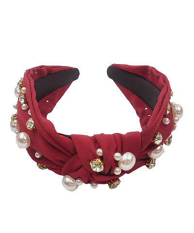 Burgundy headband with jewels and pearls.