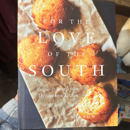 Cookbook with hushpuppies on the cover displaying "For the love of the South".