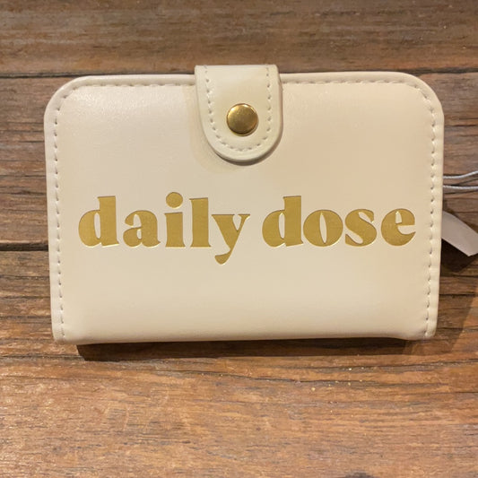 Off white pill box with button clasp featuring "daily dose" in golden lettering.