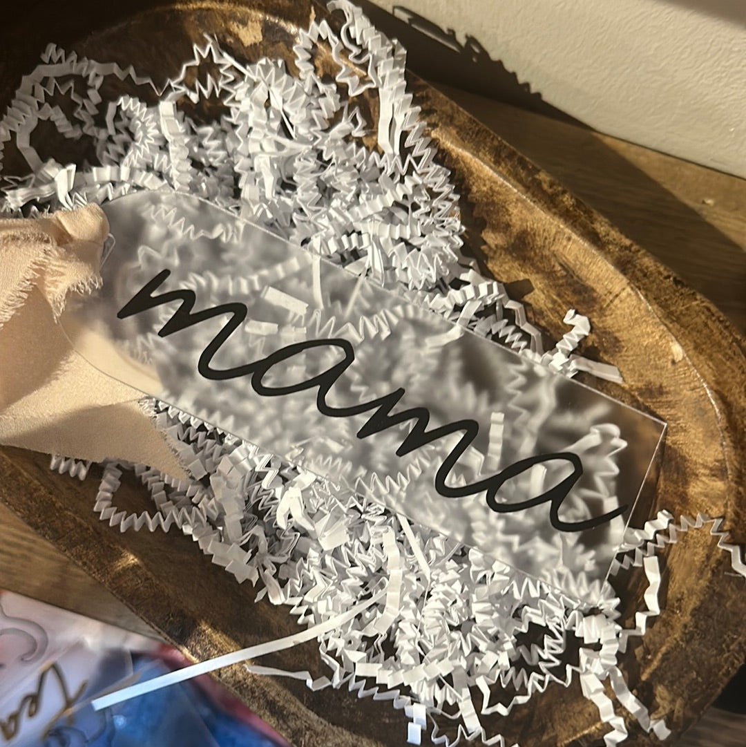 Clear acrylic bookmark with black lettering featuring "mama".