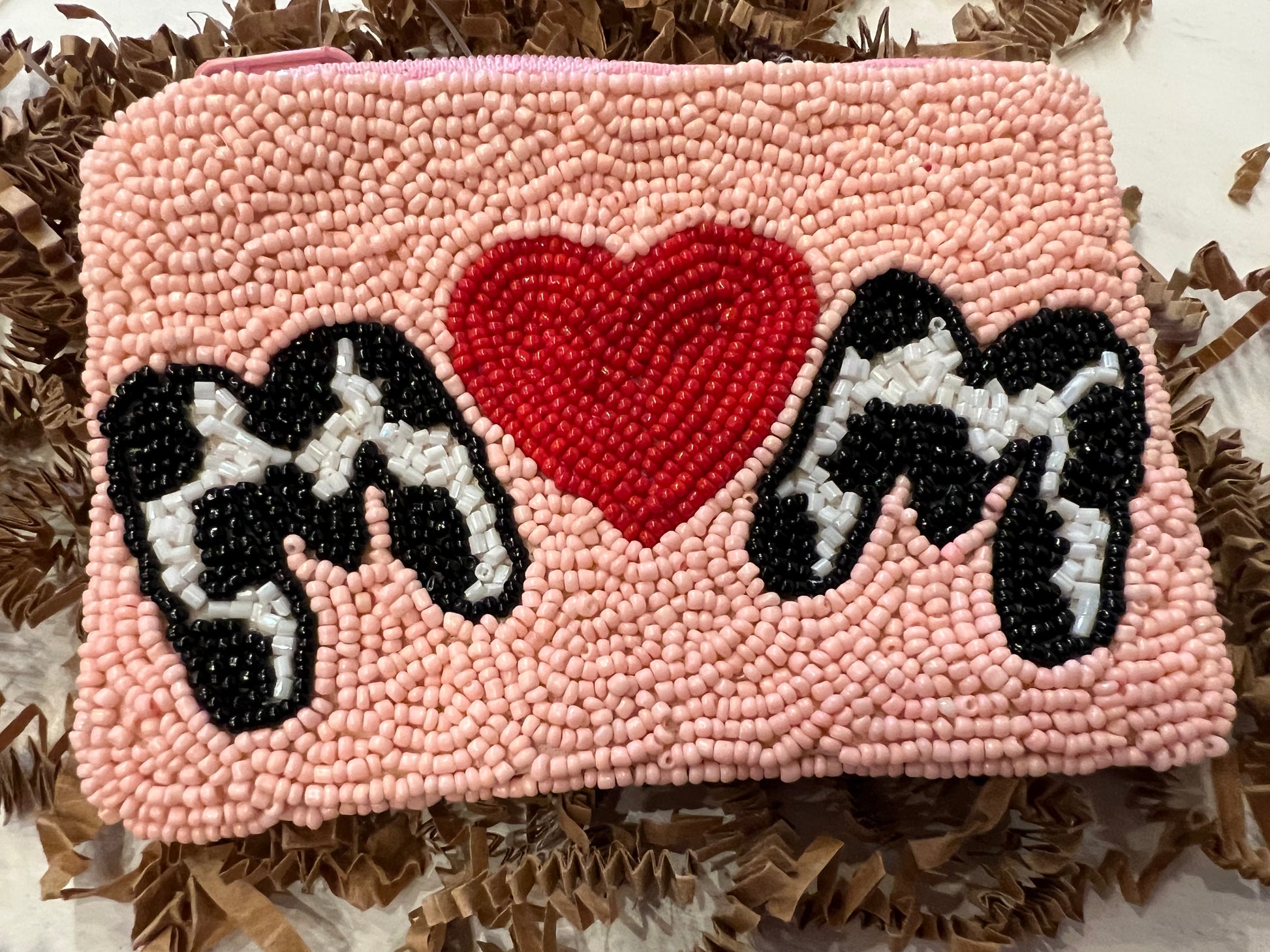 Square pink beaded coin bag featuring "MOM" in cow print beading with the "o" as a red beaded heart.