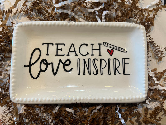 White trinket tray displaying "Teach, Love, Inspire" with a heart and pencil.