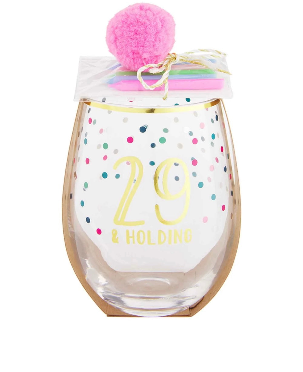 Pink stemless wine glasses with confetti details that says "29 & Holding".