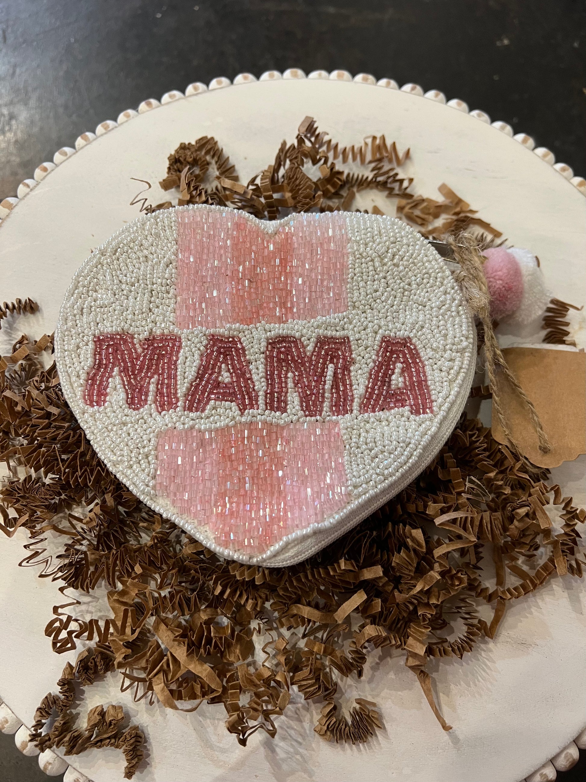 White heart shaped beaded coin bag featuring "MAMA" in pink beading.